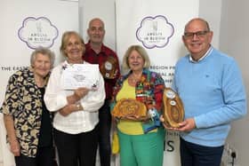 Members of Woburn in Bloom celebrated after receiving the Gold and Best Large Village Award