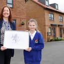 The Winner of the Art Competition Pictured with her piece of Artwork
