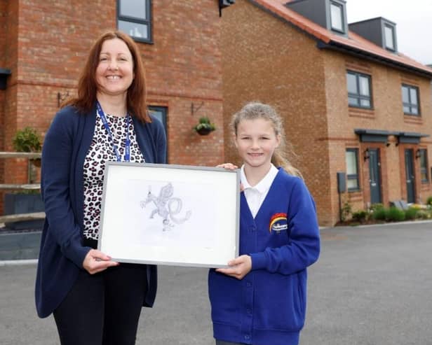 The Winner of the Art Competition Pictured with her piece of Artwork