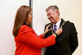 Incoming mayor Kevin Pughe accept the chains of office from outgoing mayor Farzana Kharawala. Photo: June Essex