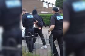 Bedfordshire Police lead one of the suspects away. PIC: Bedfordshire Police
