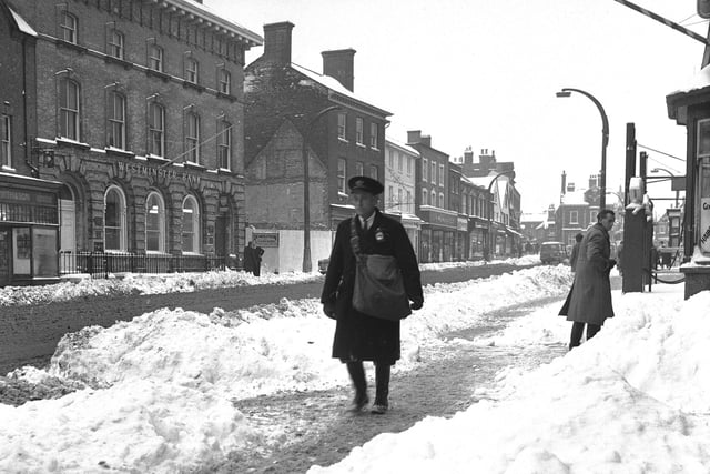 Mr Temple, the barber, clearing the snow.