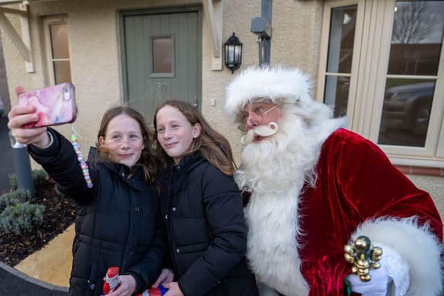 Santa helped bring festive cheer to the development by giving out gifts and posing for selfies