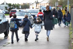 Parents walk their children to school Nick Ansell/PA Wire