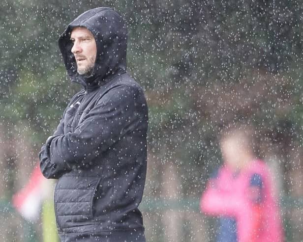 Gary Flinn watches on in the rain against Waltham Abbey. Photo by Mandy Davies.