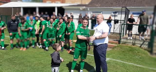 St Josephs captain Sean Bishop receives the Leighton League Premier Cup from league chairman Dave Snaith
