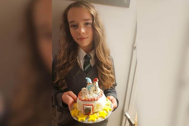 Remi-Ann Paice with the Christmas cake she's auctioning for Keech Hospice Care. She wants to be just like her late father Richard who raised lots of money for Keech when he was Morning Crew presenter 'Rentie' on Chiltern FM. Pic supplied by Sasha Paice