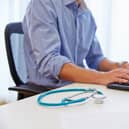 Close up of a doctor working at a computer