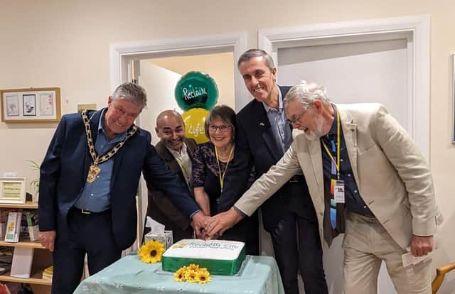 Cutting the cake are from l to r, Mayor Kevin Pughe, Clinical Consultant Dr Iqbal Mohiuddin, Linda Sear - Chairman, Andrew Selous MP, and Trustee Harry Sear.