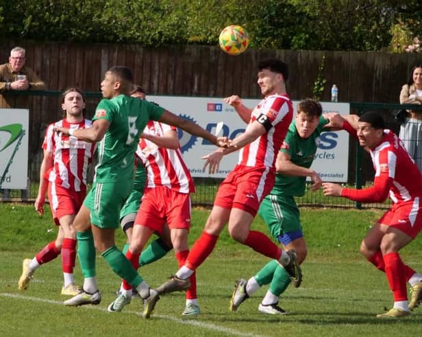 Leighton captain Lee Cooksey gets his head to a cross against Biggleswade. Photo: Andrew Parker.