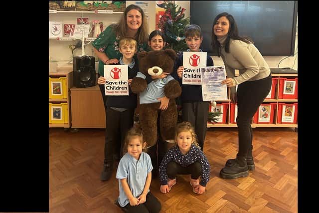 Danielle Cross with headteacher Sam Gooding and some of the children at Stanbridge Lower. Ms Gooding says Danielle is a wonderful role model for the youngsters