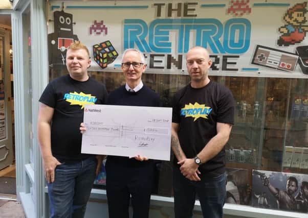 Retroplay cheque donation to KidsOut