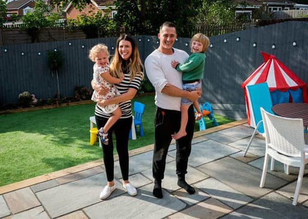 Dannielle and Luke with their chidlren in their new garden. Photo by MyBuilder