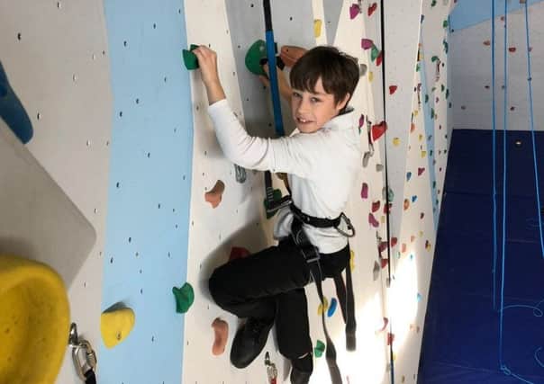 A student enjoying the new climbing wall.