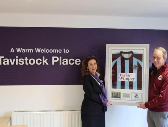 Chair of Woburn and Wavendon FC, Robert Hill with the framed shirt at the Tavistock Place sales office