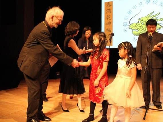 Philomena (in red dress) receives her award from the Mayor of Milton Keynes