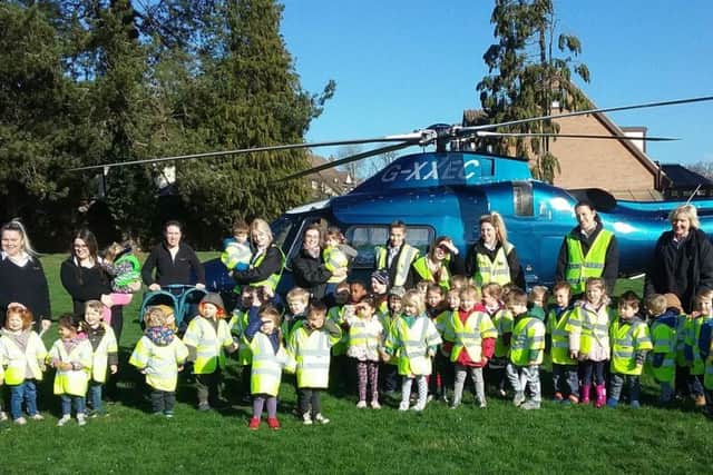 The pupils pose by the helicopter