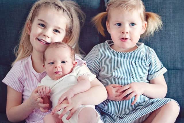 Brett's daughters Freya, 4, Ellie, 18 months, and newborn Ariya      [C. Dolly and Maisy Photography]