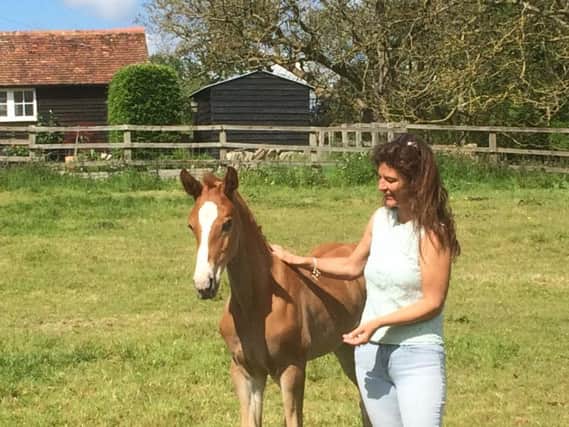 Hayley Ward with a young foal