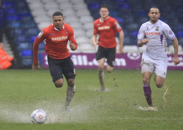 Andre Gray chases through the rain