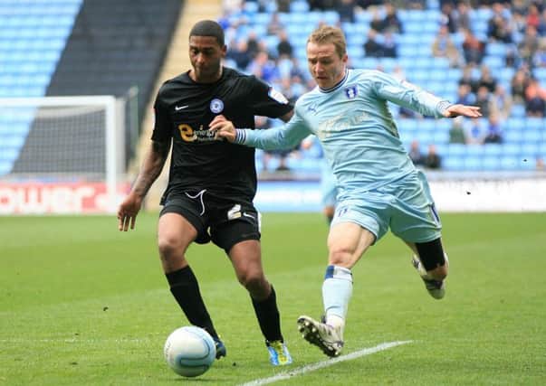 Coventry City's Gary McSheffrey and Peteborough United's Mark Little during the npower Football League Championship match at the Ricoh Arena, Coventry. PRESS ASSOCIATION Photo. Picture date: Saturday April 7, 2012. Photo credit should read:PA Wire. RESTRICTIONS. Editorial use only. Maximum 45 images during a match. No video emulation or promotion as 'live'. No use in games, competitions, merchandise, betting or single club/player services. No use with unofficial audio, video, data, fixtures or club/league logos.