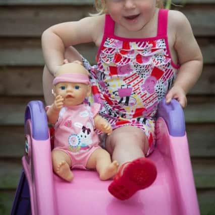 Emily Williams age 2 with her baby doll from Toy's R Us. Photo: SWNS