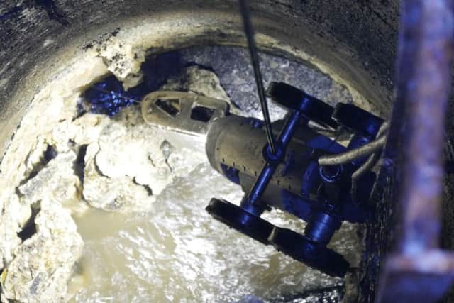 The pipe being cleaned by the robot at Houghton Regis in Bedfordshire. See Masons copy MNFAT: A water pipe became so clogged up with cooking fat that the water company was forced to call in a giant robot from Holland. The gruesome blockage, caused by congealed fats and oils poured down plugholes, took several days to clear using a special high-powered jet mounted on a remote controlled robot. Anglian Water has now made an urgent appeal for homeowners to stop pouring such substances down the sink, after the equivalent of eight Olympic sized swimming pools full of fat makes its way into East Anglia's sewers each year.