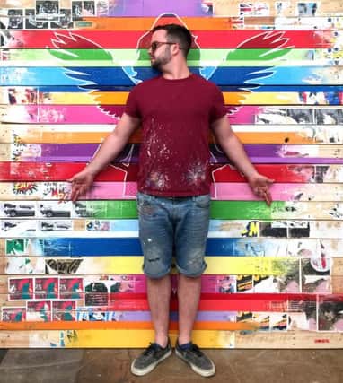 Bletchley artist Lhouette in front of one of his pop art creations