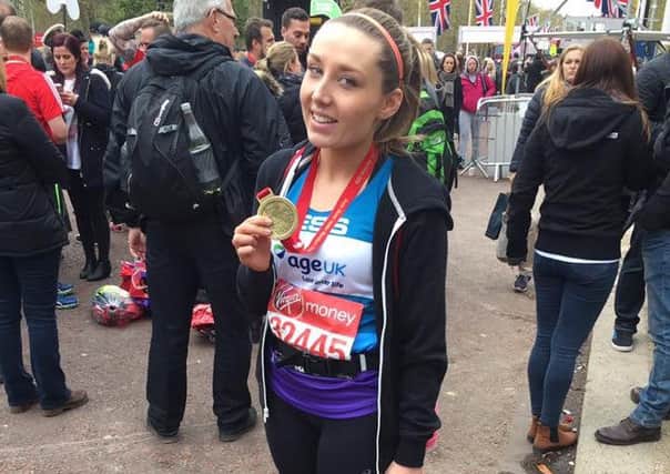 Jess after completing the London marathon for Age UK