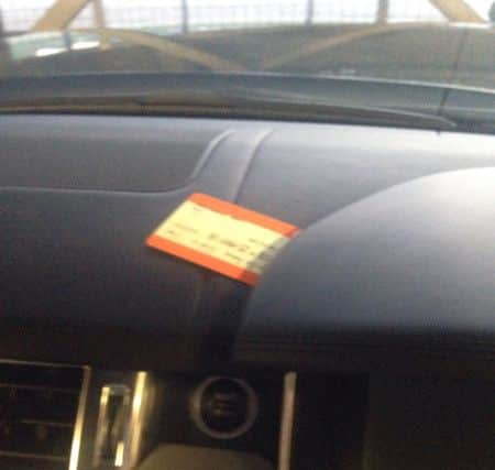 The ticket on the dashboard of Julian's car