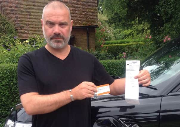 Julian with the parking ticket he purchased and the parking charge notice from Indigo