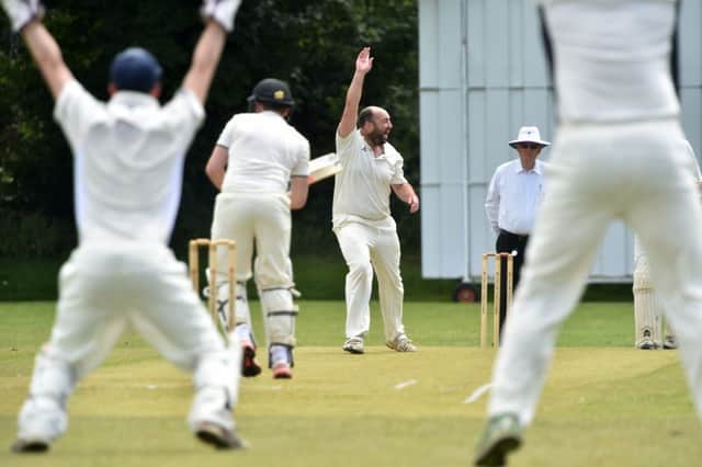 Leighton's Dan Scott celebrates taking a wicket against Aston Rowant
