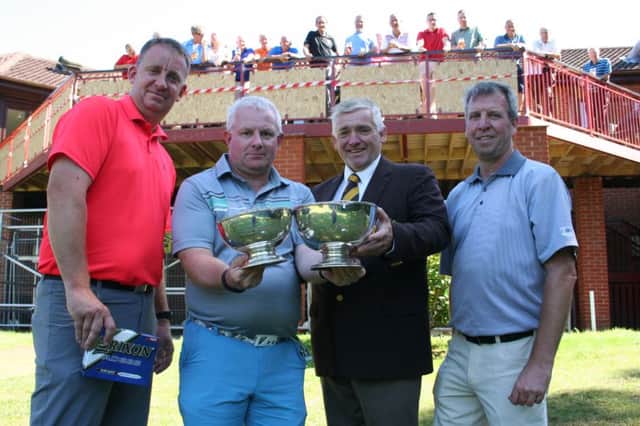 JUST CHAMPION&.runner-up Greg White, winner Paul Atkinson being presented with his trophies by Club Captain Adrian Stephenson and handicap trophy runner-up Steve Richardson.