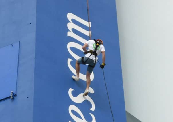 Former Cedars  Upper student Dave Rourke abseiling down the Emirates Spinnaker Tower in Portsmouth for Dogs for Good