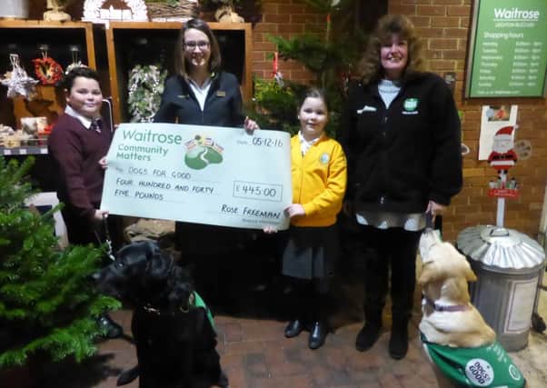 Barbara Betts from Waitrise presenting Dogs For Good fundraiser Annie Rourke with a big cheque. Finn Stannard (left), pictured with his sister Neve-Adriana, has an autism assistance dog