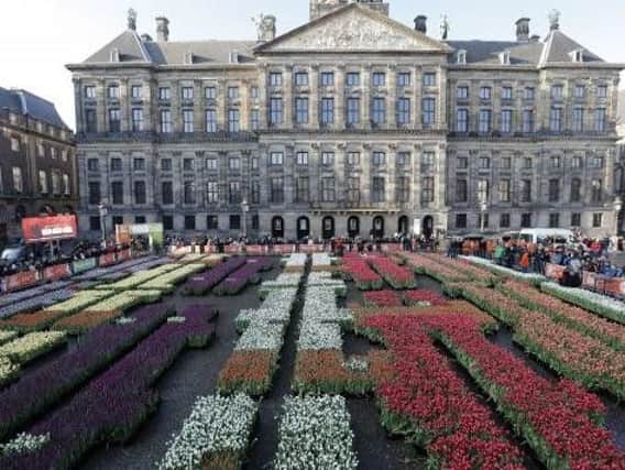 Dam Square in Amsterdam was awash with spring colour on National Tulip Day.