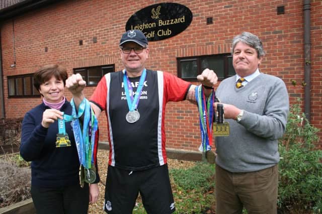 MEDALLION MAN&.Mark McLoughlin with Leighton Ladies Captain Avril Simpson and Club Captain John Smith, who are raising funds for local charities.