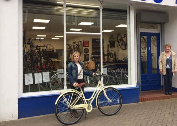 Bev Pledger with her new bike outside Dorvic's which is offering victims of cycle theft a discount, provided they can produce a crime number