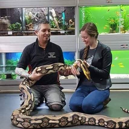 Julian, reporter Jo, and Grace, a Tiger Reticulated Python (Python Reticulatus).