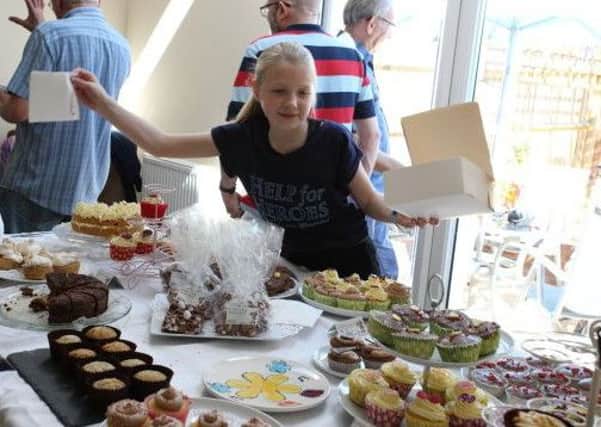Keen young baker Olivia Shipley with some of the cakes she made for the Help for Heroes sale