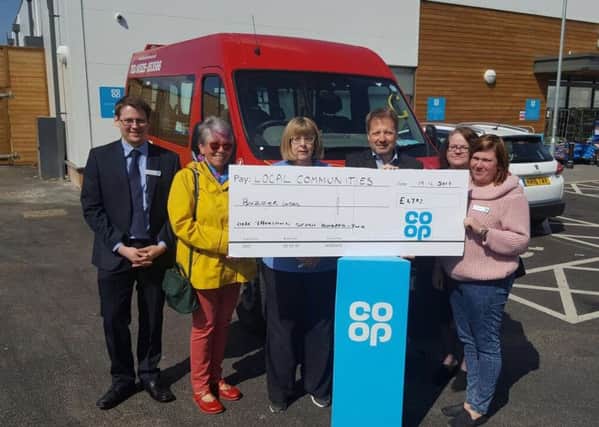 Stanbridge Road Co-op staff present Buzzer Buses with a bumper cheque for Â£1,702