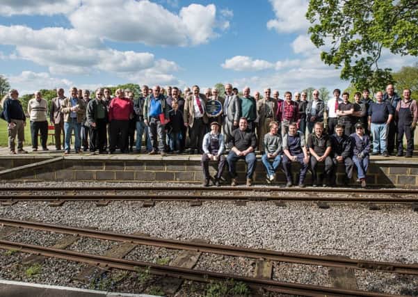 Leighton Buzzard Railway volunteers celebrate their award from the Heritage Railway Association