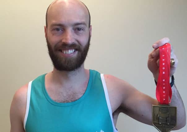 Pistone father-of-one James Westcott with his medal after completing the London Marathon in aid of The National Brain Appeal and MND