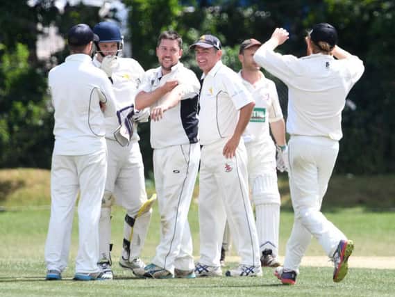 Antony Francis celebrates taking a wicket for Leighton