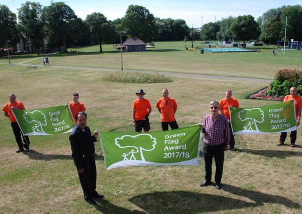 Town Mayor Cllr Syed Rahman and Deputy Mayor Cllr Clive Palmer holding the newly awarded flags with some of the councils  grounds team.