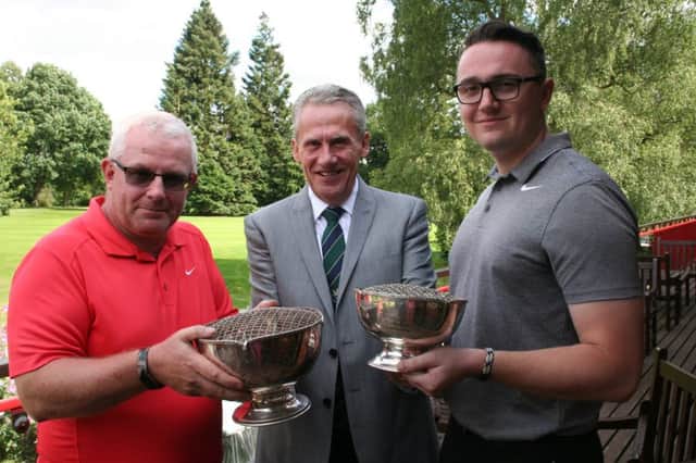 Paul Atkinson (left) and Jamie Stone (right) with club Vice Captain Jeremy Taylor and their trophies.